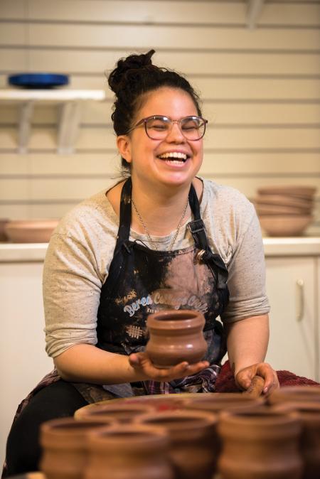 Student ceramist Zoe ‘20 enjoys spinning pottery in the College’s Visitor Center and Shoppe.