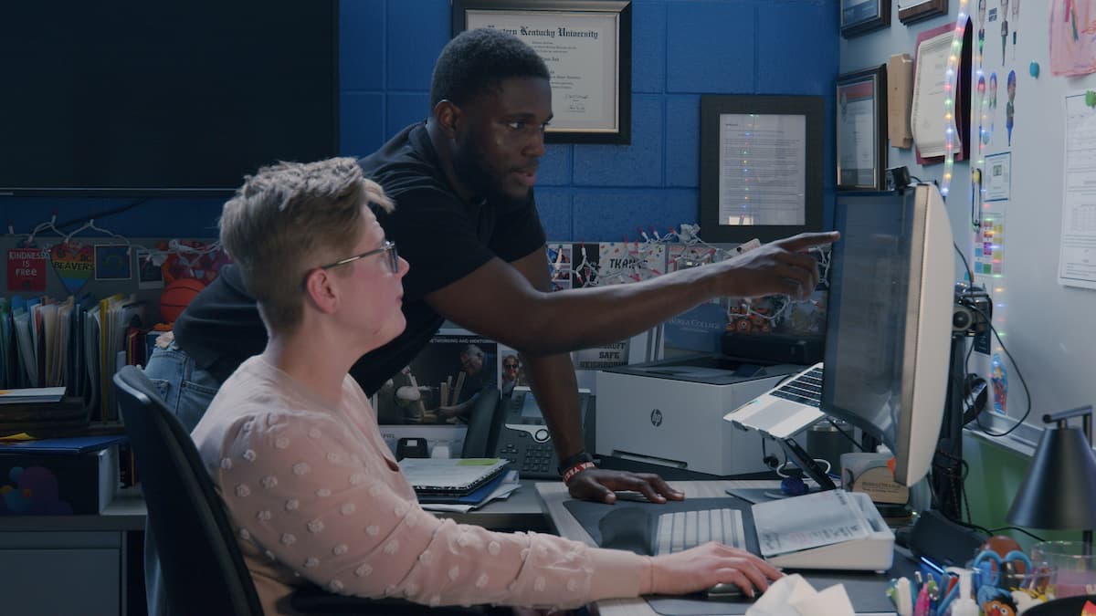 college staff looking at reports